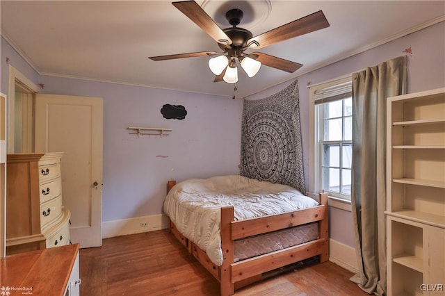 bedroom featuring ornamental molding, hardwood / wood-style floors, and ceiling fan