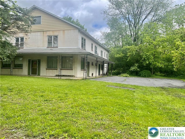 403 N Walnut St, Bath Borough, PA 18014 - back of house with stucco siding, a yard, and covered porch