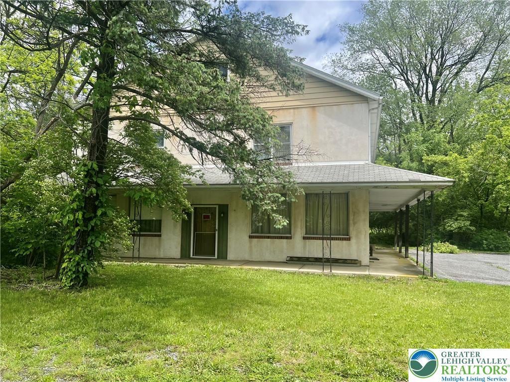 403 N Walnut St, Bath Borough, PA 18014 - back of house with stucco siding, a yard, and a porch