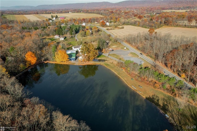 birds eye view of property featuring a water view and a rural view