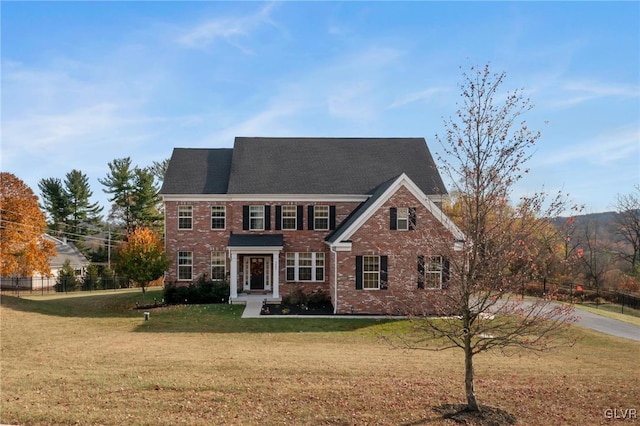 colonial-style house with a front yard