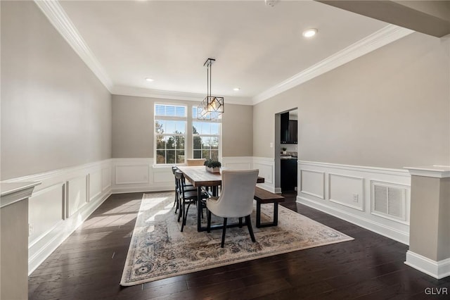 dining room with dark hardwood / wood-style flooring and ornamental molding