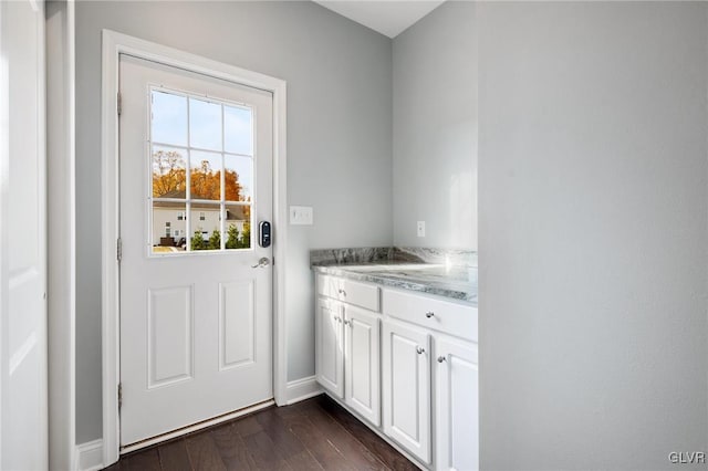 doorway with dark wood-type flooring