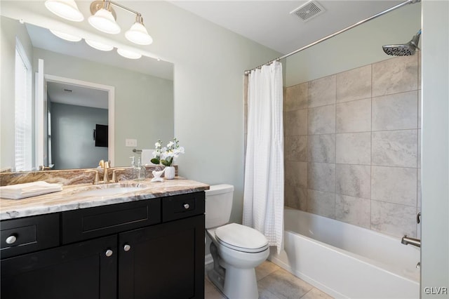 full bathroom featuring toilet, shower / bath combo, vanity, and tile patterned flooring