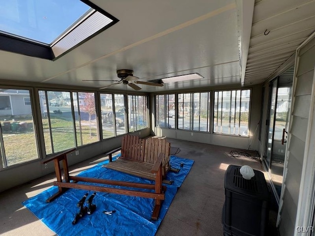 sunroom / solarium featuring a skylight, ceiling fan, and plenty of natural light