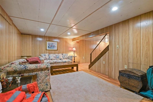 living room with wood walls and wood-type flooring