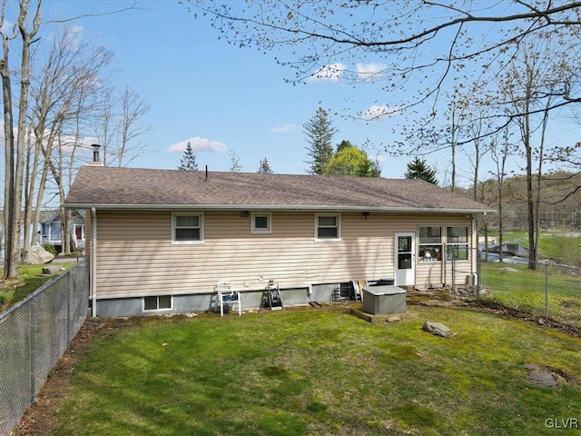 rear view of house with a yard