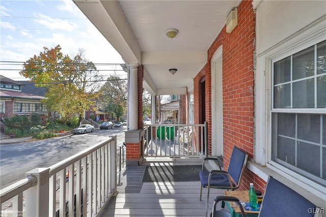 wooden terrace featuring covered porch