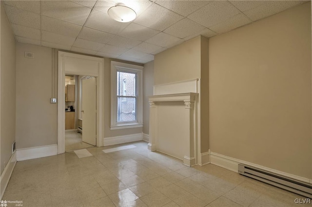 22 S 13th St, Allentown City, PA 18102 - empty room featuring a baseboard radiator, baseboards, and a drop ceiling