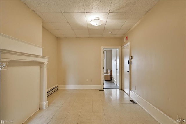 22 S 13th St, Allentown City, PA 18102 - unfurnished living room featuring baseboard heating, a drop ceiling, and baseboards