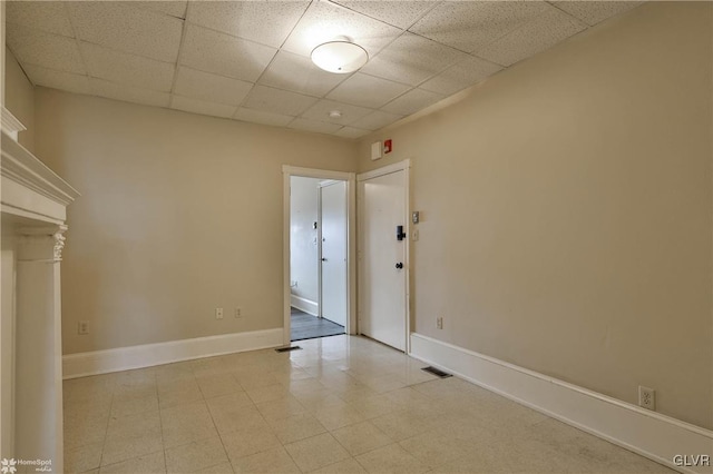 empty room featuring a paneled ceiling