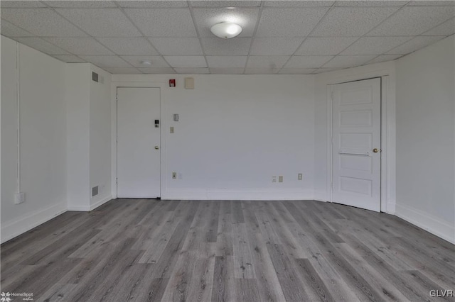 unfurnished room featuring a paneled ceiling and light hardwood / wood-style floors