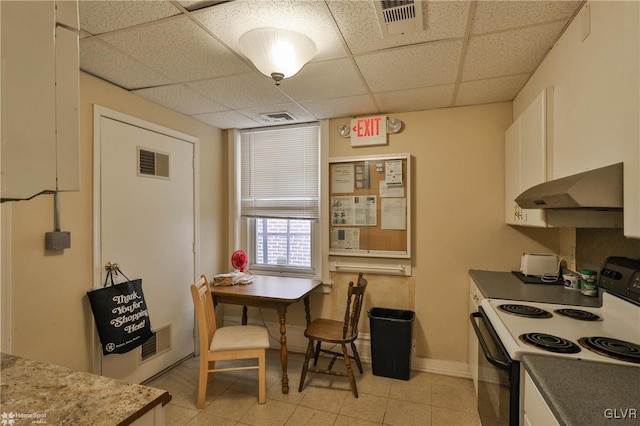 kitchen with white cabinets, a paneled ceiling, and white range with electric stovetop