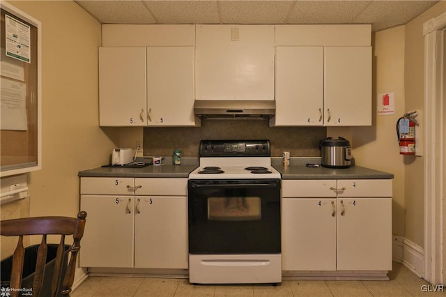 kitchen with white cabinets, a paneled ceiling, light tile patterned floors, and white range with electric stovetop