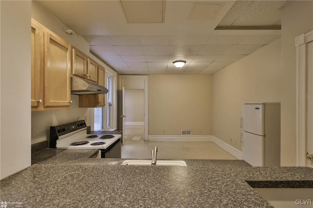 kitchen featuring a drop ceiling, sink, and white appliances