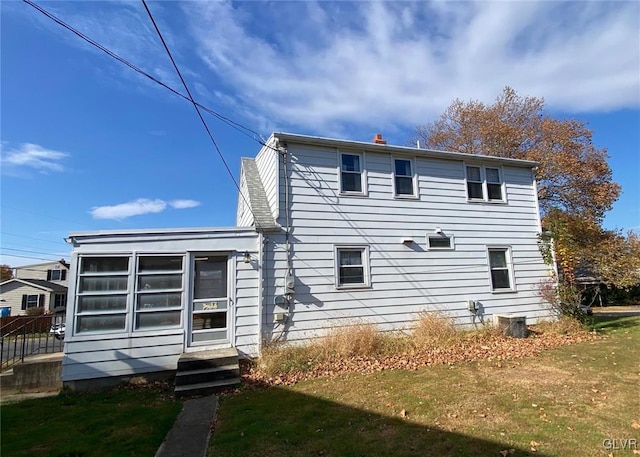 back of house with a yard