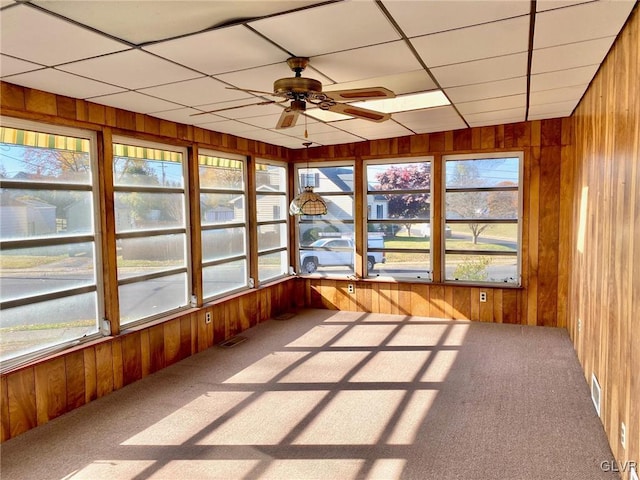 unfurnished sunroom featuring ceiling fan