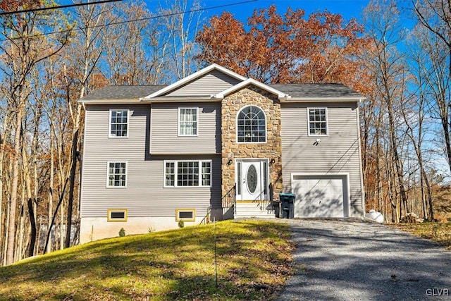 view of front of house with a front lawn and a garage