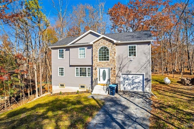 view of front of property with a garage and a front lawn