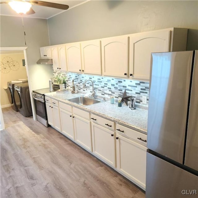 kitchen featuring stainless steel appliances, white cabinets, sink, and light wood-type flooring