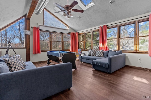 sunroom / solarium featuring ceiling fan, vaulted ceiling with skylight, a healthy amount of sunlight, and billiards