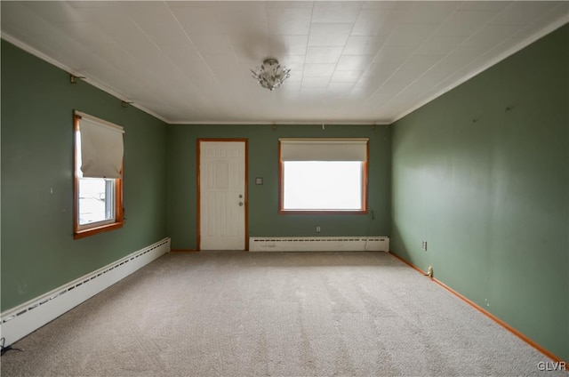 unfurnished room featuring carpet floors, crown molding, and a baseboard heating unit