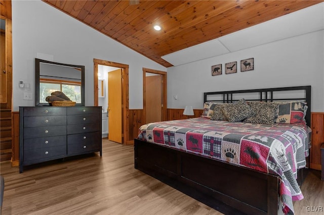 bedroom with light hardwood / wood-style flooring, vaulted ceiling, wood walls, and wooden ceiling