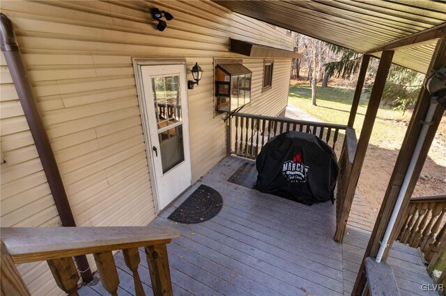 wooden terrace featuring grilling area