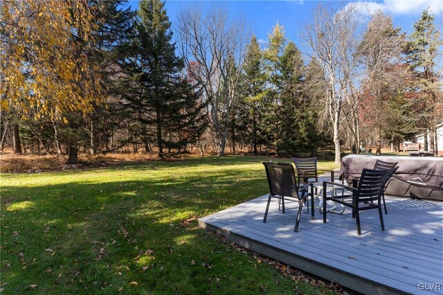 wooden terrace featuring a yard