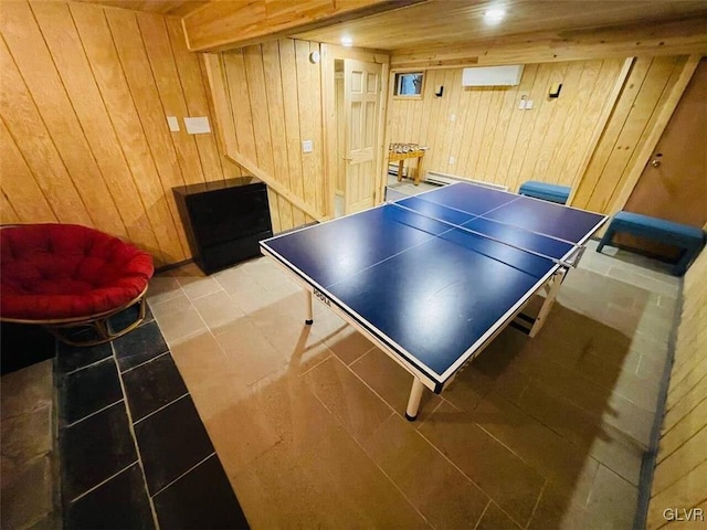 recreation room with wooden walls