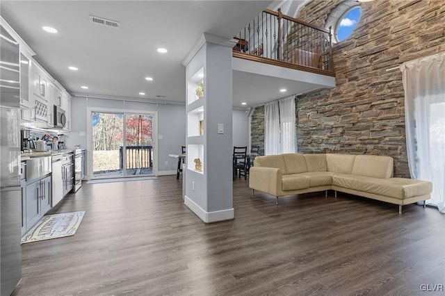 unfurnished living room featuring dark wood-type flooring