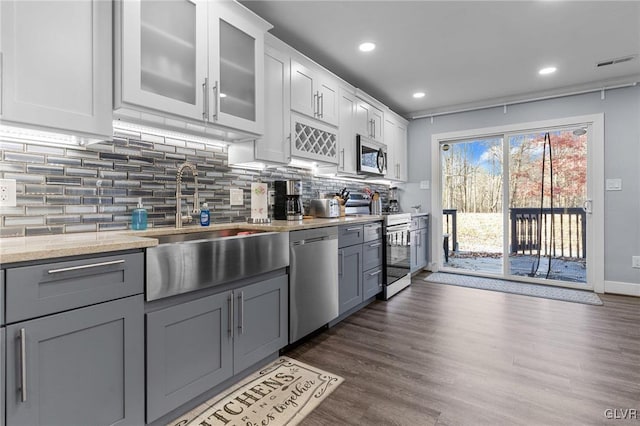 kitchen featuring white cabinetry, gray cabinets, appliances with stainless steel finishes, dark wood-type flooring, and sink