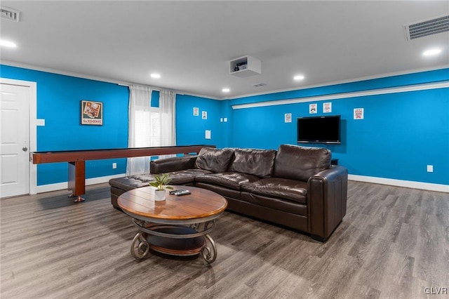 cinema featuring crown molding and hardwood / wood-style flooring