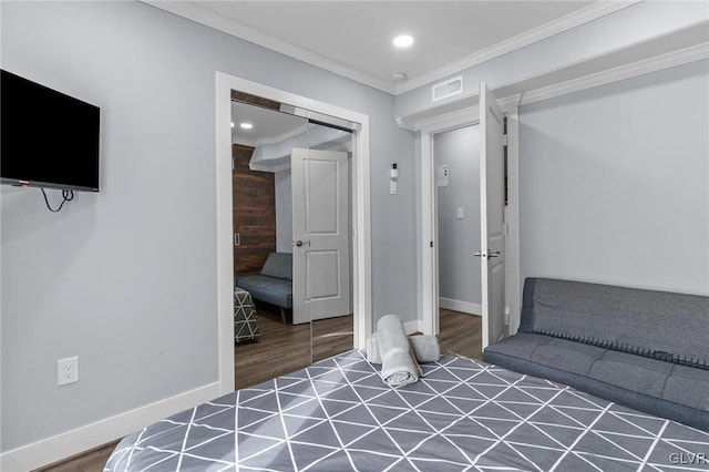 bedroom featuring dark hardwood / wood-style floors, a closet, and ornamental molding