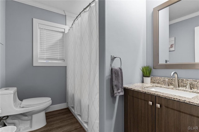 bathroom with toilet, vanity, crown molding, and hardwood / wood-style floors