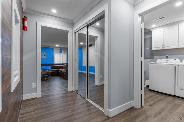 corridor featuring crown molding, separate washer and dryer, and hardwood / wood-style floors