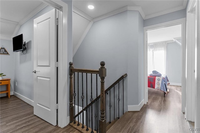 hallway featuring ornamental molding and hardwood / wood-style flooring