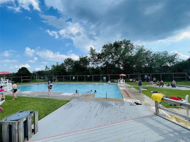 view of swimming pool with a yard and a patio