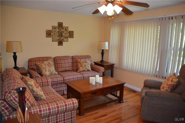 living room featuring ceiling fan and light hardwood / wood-style floors