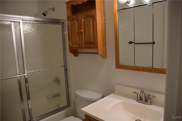 full bathroom with shower / bath combination with glass door, vanity, and toilet