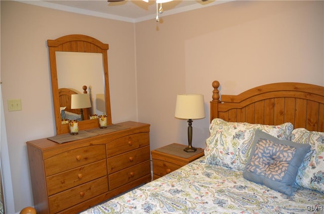 bedroom with ornamental molding and ceiling fan