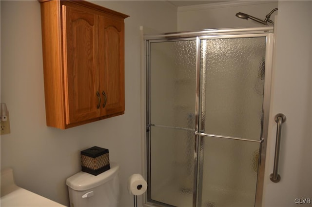 bathroom with toilet and an enclosed shower