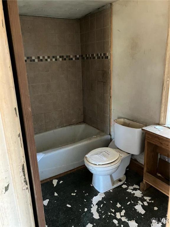 bathroom with tile patterned flooring, vanity, and toilet