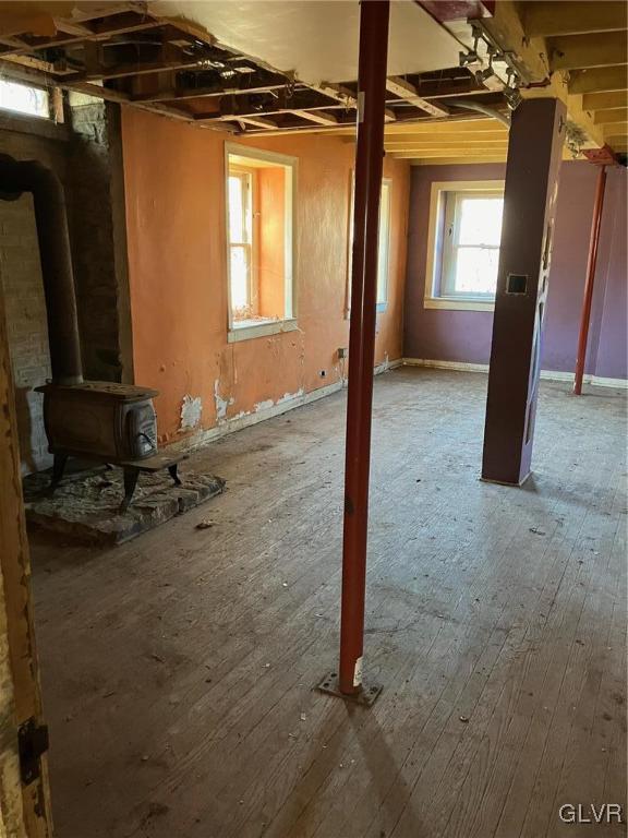 interior space featuring a wood stove and hardwood / wood-style floors