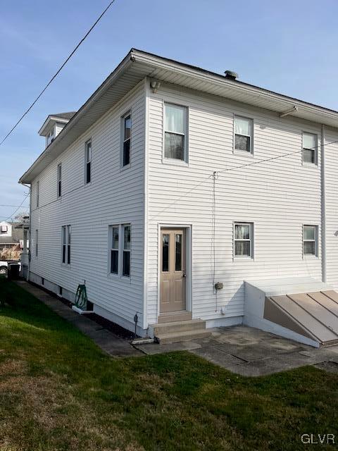 rear view of property with a yard