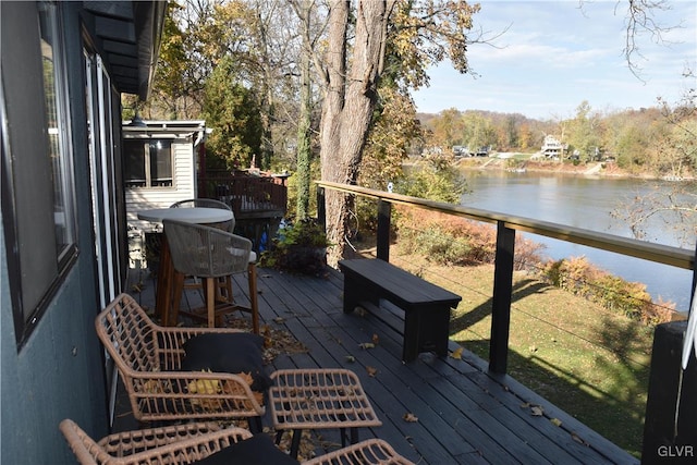 wooden terrace featuring a water view