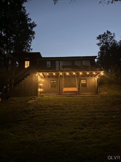 view of back house at dusk