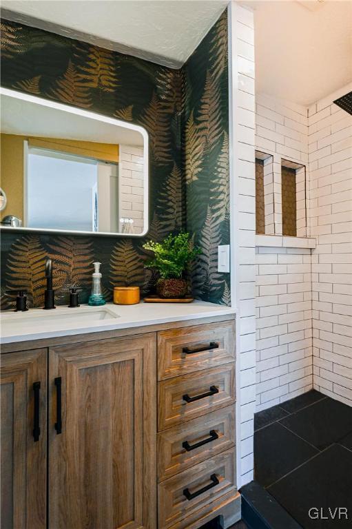 bathroom featuring a shower and vanity