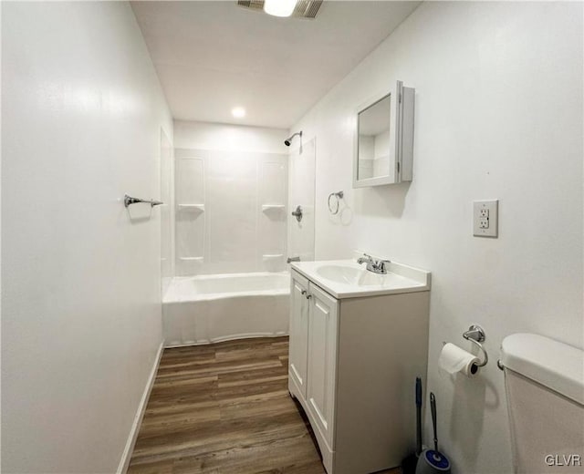 full bathroom with hardwood / wood-style flooring, vanity, toilet, and bathing tub / shower combination