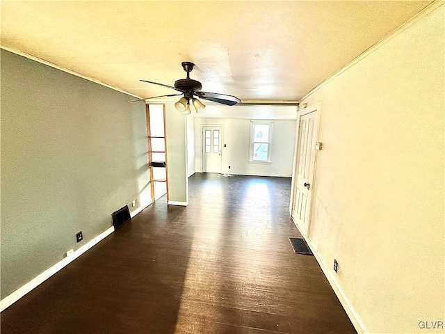 empty room featuring ornamental molding, ceiling fan, and dark hardwood / wood-style floors